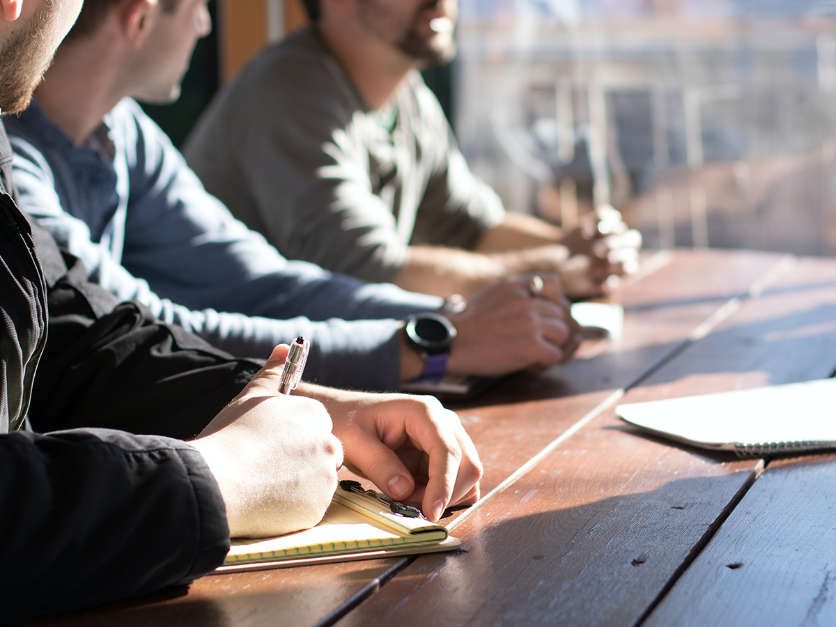 1200x900GMB-3-6220fb4d905a7 community of guys sitting at table