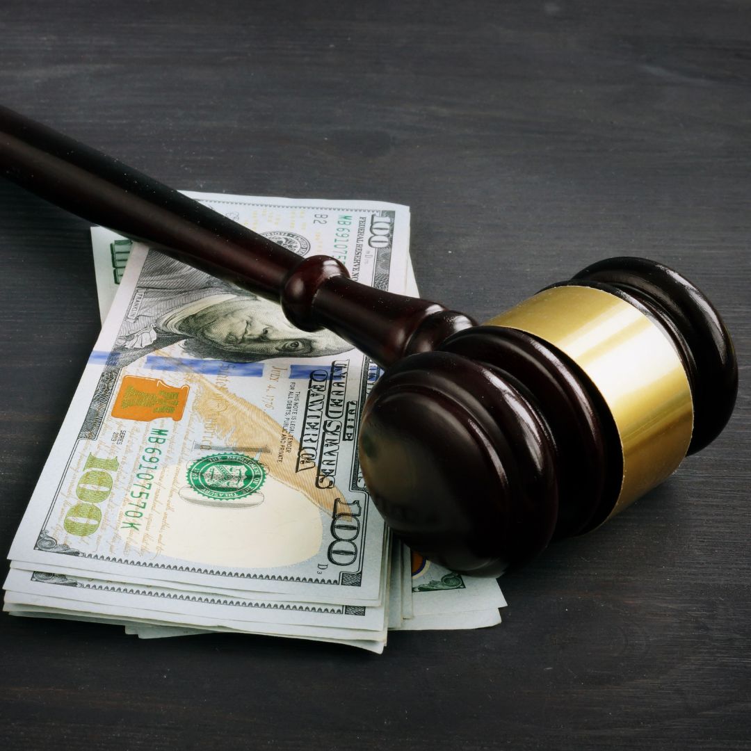Gavel on top of a stack of money. 
