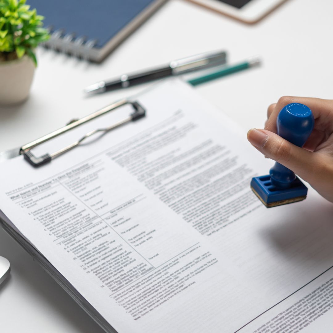 person stamping official documents